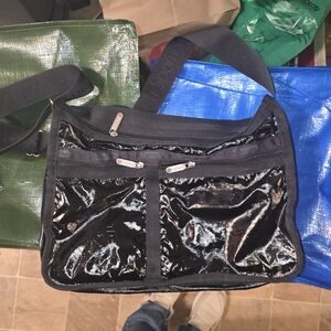 LeSportsac Deluxe Everyday Bag in a black patent finish